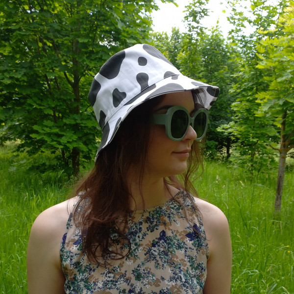 Bucket hat with cow print made of cotton. Fashionable unisex designer hat. Cute animal print hat. Summer hat for travel.