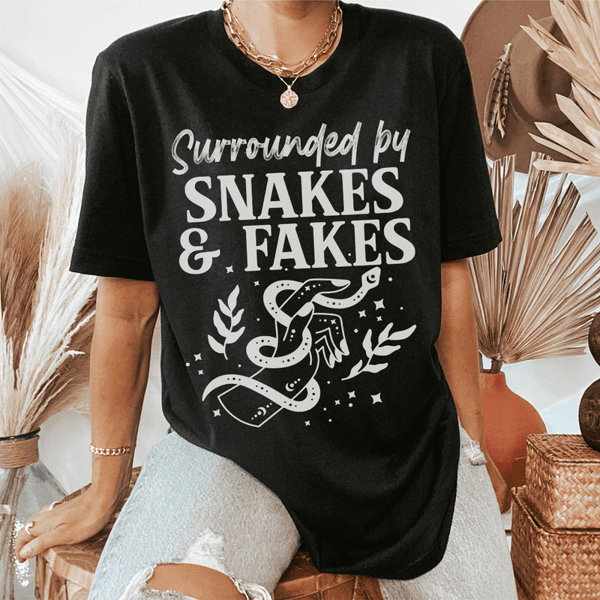 surrounded-by-snakes-fakes-tee-black-heather-s-peachy-sunday-t-shirt