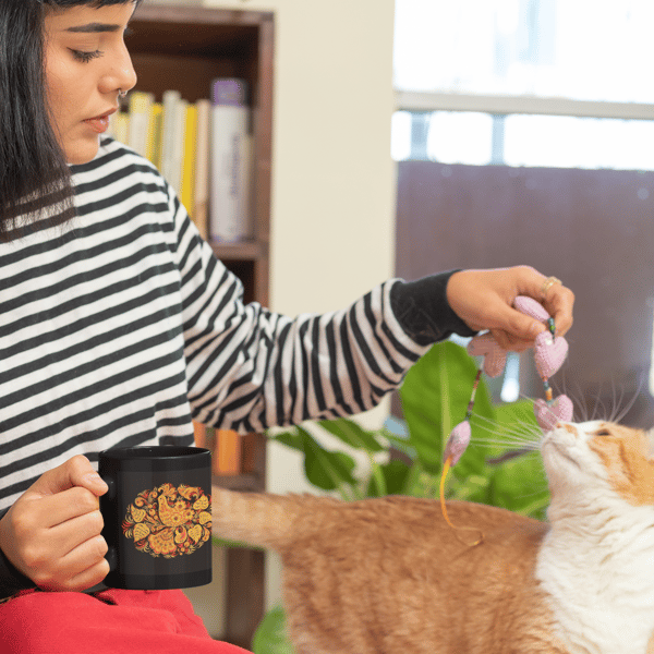 11-oz-mug-mockup-of-a-woman-playing-with-her-cat-at-home-30667.png