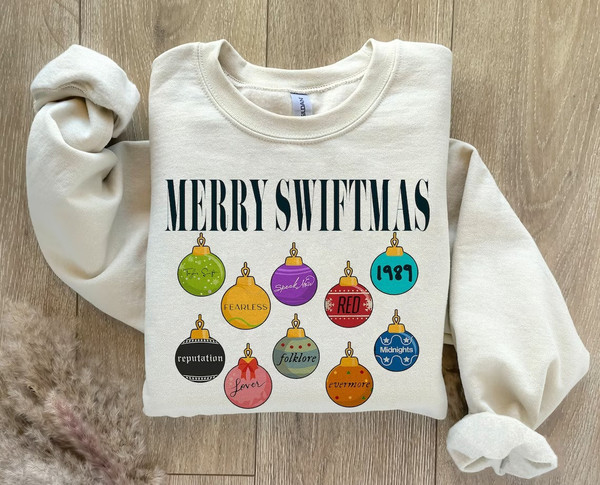 Merry Swiftmas Sweatshirt, Cute Famous Christmas Ball Shirt, The Eras Tour Christmas shirt, The Eras Tour Christmas TS Version, Gift For Fan 1.jpg