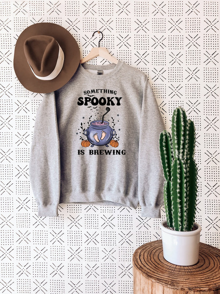 Something Spooky Is Brewing Sweatshirt, Halloween Pregnancy Announcement Shirt, Halloween Maternity Sweater.jpg