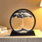 movingsandartpictureroundglass3dblack.png
