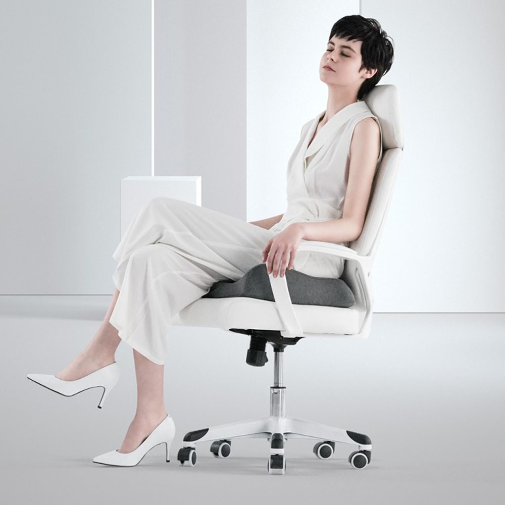 Ergonomic hip support pillow on office chair for back pain relief