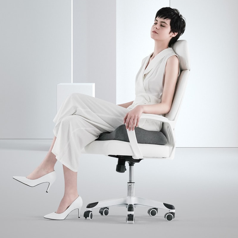 Ergonomic hip support pillow on office chair for back pain relief