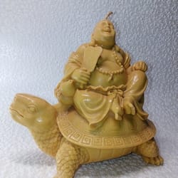 candle figurine. buddha on a turtle. wax candle. beeswax candle. statuette.