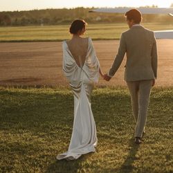 mermaid wedding dress with an open back and a long train. long classic ecru satin wedding dress vanessa