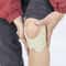 Natural knee pain relief patch being applied smoothly