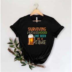 surviving fatherhood one beer at a time shirt, funny papa shirt, funny dad life tee daddy gifts, best father shirt, papa