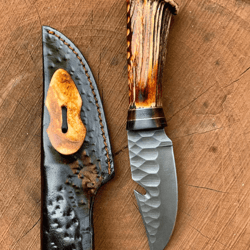 hand-forged carbon steel skinner knife – antler handle, 4.5 gut hook drop-point blade, leather sheath