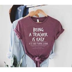 being a teacher is easy, it's like riding a bike shirt, funny teacher shirt, back to school teacher tee,cute teacher out
